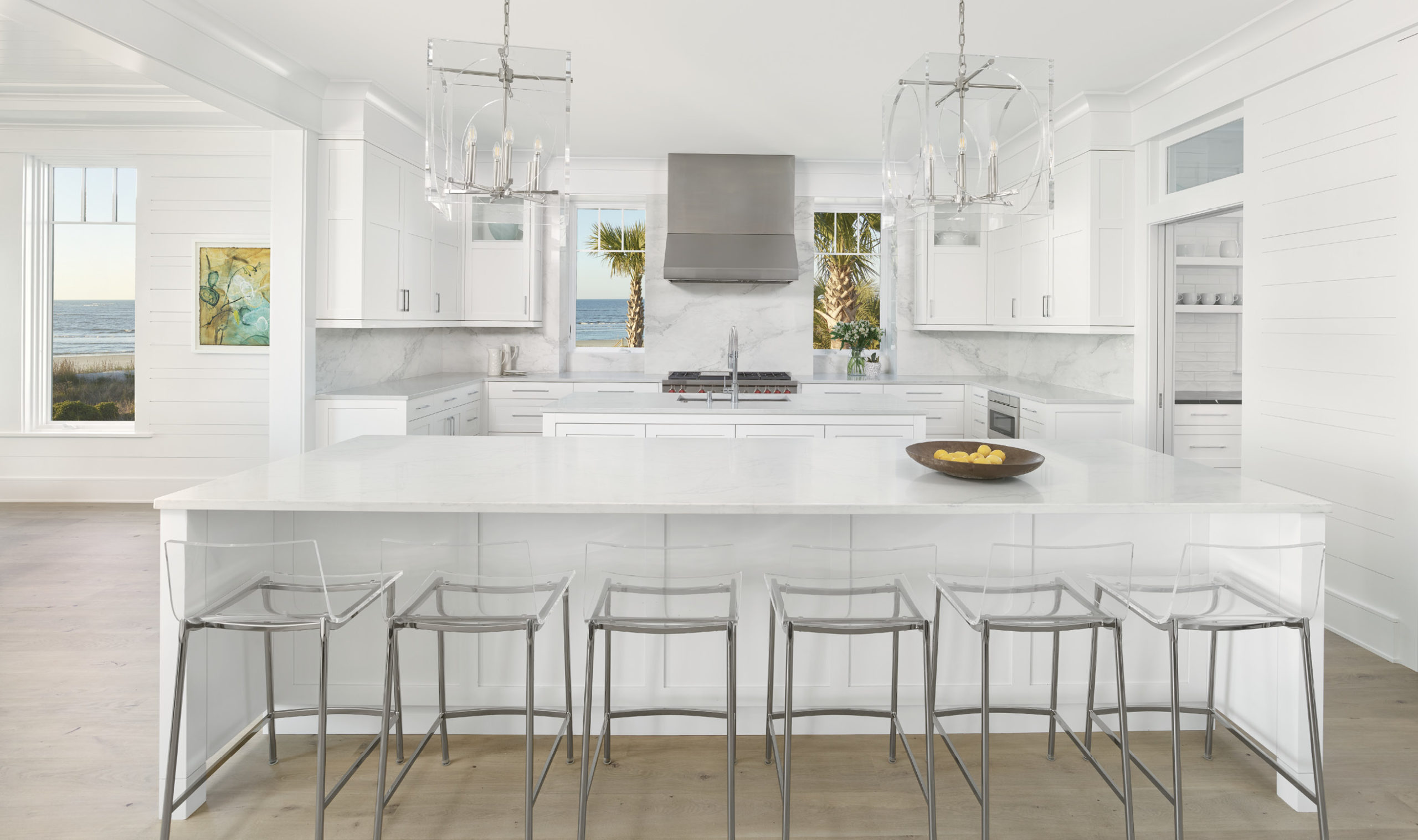 The kitchen was designed with simplicity and durability in mind, with quartz countertops and islands, a marble backsplash and easy-to-clean acrylic counter seating.