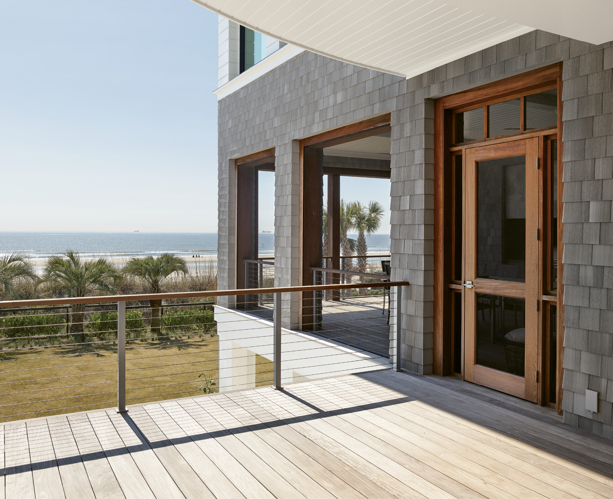 The outdoors and indoors meld seamlessly as most rooms have ocean views. For the exterior, builder Zac Naramore chose NuCedar shingles, a synthetic product with the colors extruded into the finish for a weathered, authentic look.